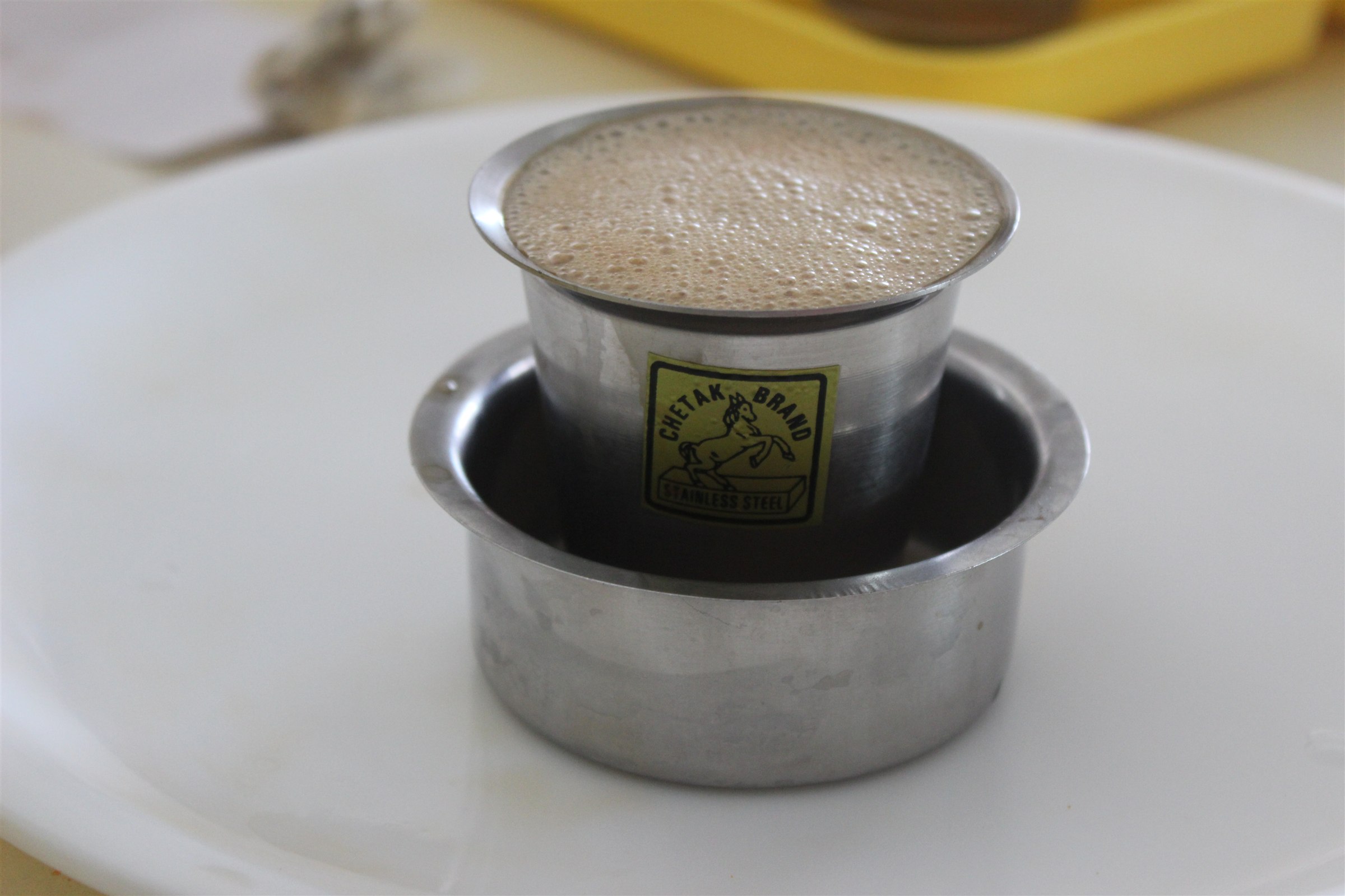 South Indian filter coffee served in a steel tumbler and dabarah